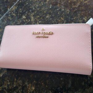 NWOT Kate Spade Pink Wallet measures 6 3/4in by 3 3/4 in